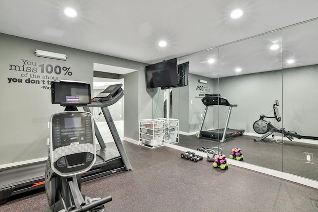 workout area featuring recessed lighting and baseboards