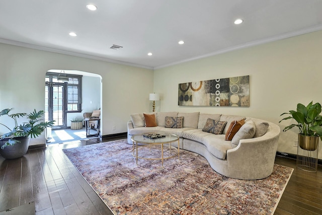 living area with baseboards, visible vents, arched walkways, dark wood-style flooring, and ornamental molding