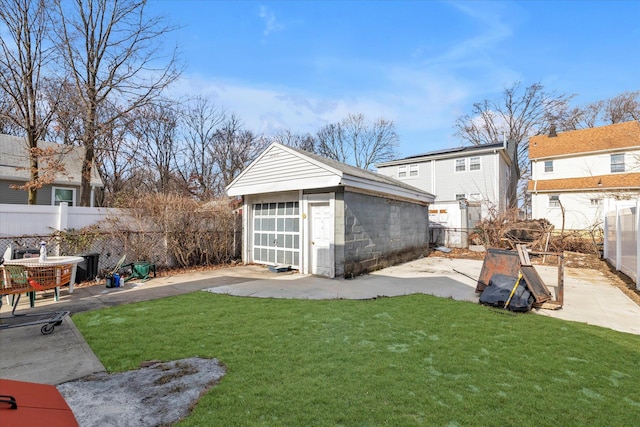 view of yard with an outbuilding, a fenced backyard, and a patio