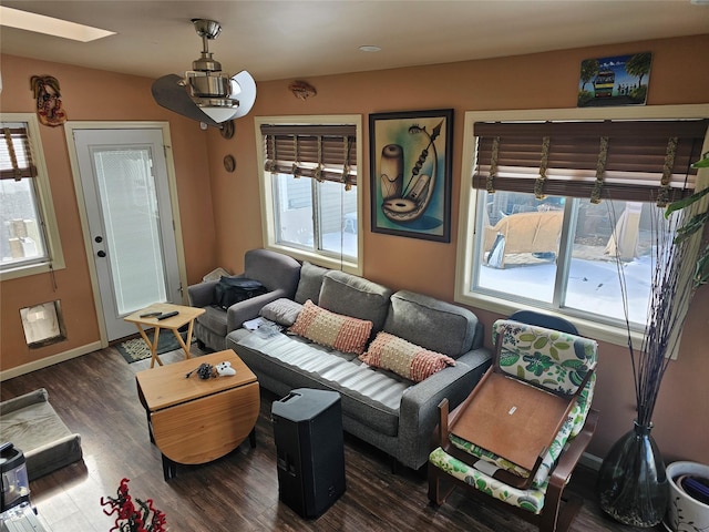 living room featuring dark hardwood / wood-style flooring and a skylight