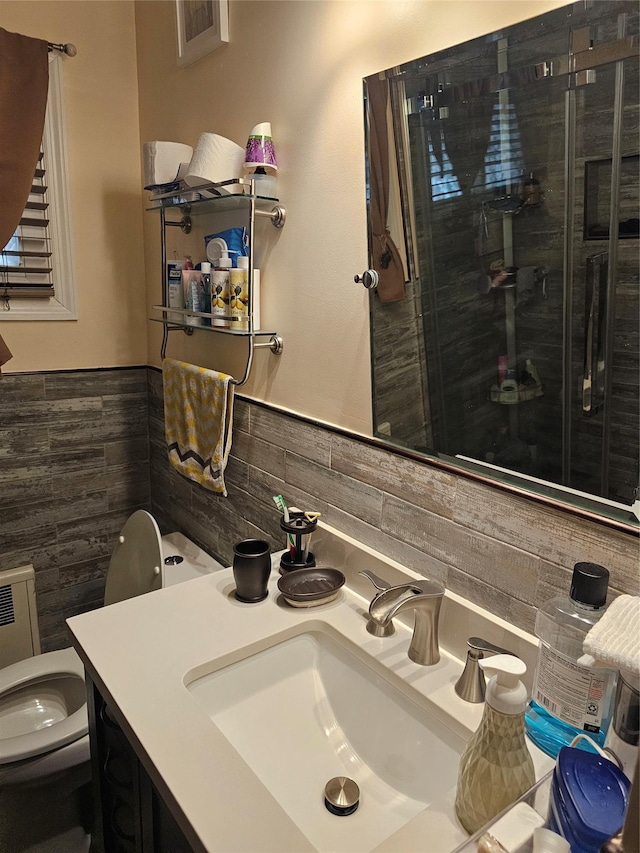 bathroom with tile walls, vanity, and toilet