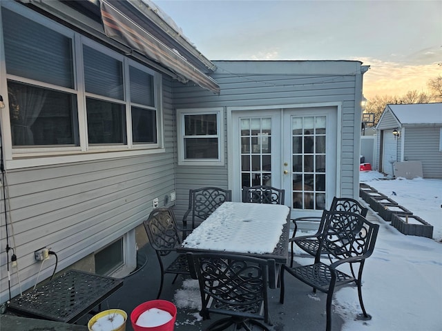 snow covered patio with french doors