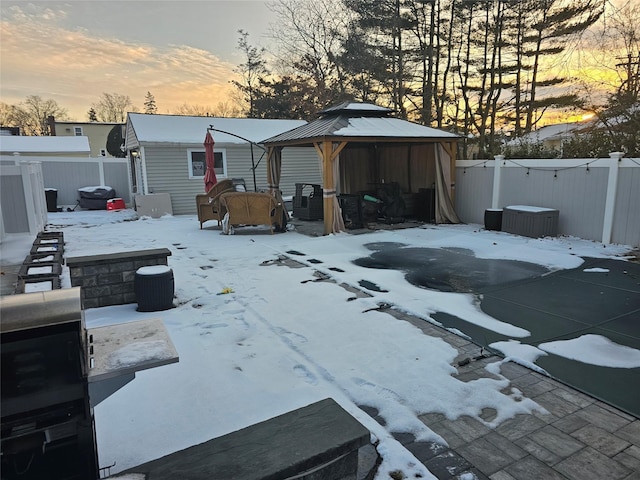 snowy yard featuring a gazebo