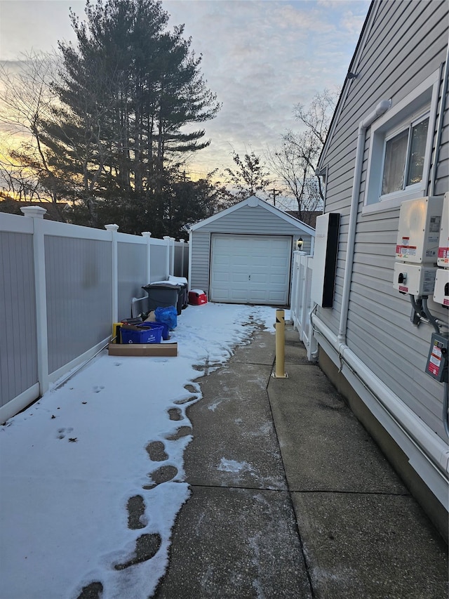 yard at dusk featuring a garage and an outdoor structure