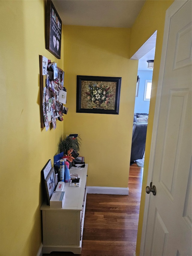 corridor with dark hardwood / wood-style flooring