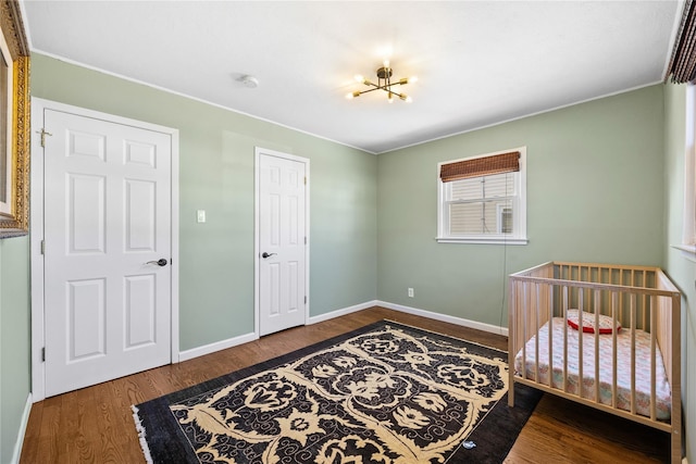 bedroom featuring baseboards and wood finished floors