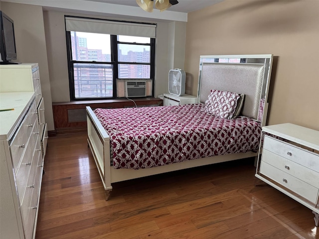 bedroom with dark wood-type flooring