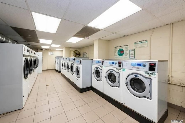 laundry area with light tile patterned floors and separate washer and dryer