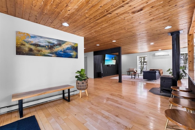 interior space featuring a wall unit AC, wooden ceiling, a wood stove, light wood-type flooring, and recessed lighting