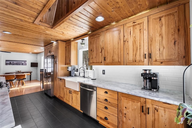 kitchen featuring decorative backsplash, appliances with stainless steel finishes, light countertops, and a sink