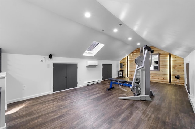 workout area featuring a baseboard heating unit, dark wood-type flooring, wooden walls, and lofted ceiling with skylight