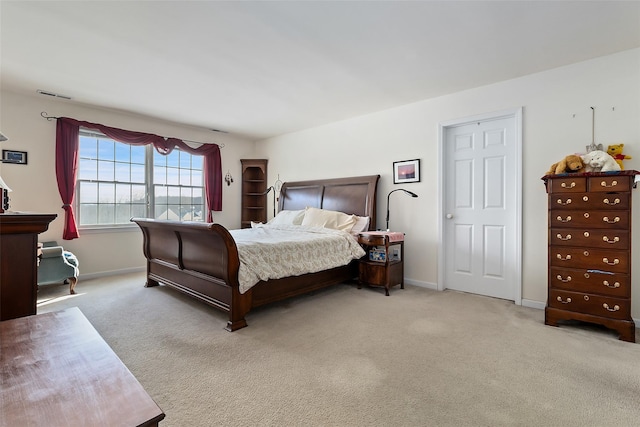 bedroom with light carpet, visible vents, and baseboards