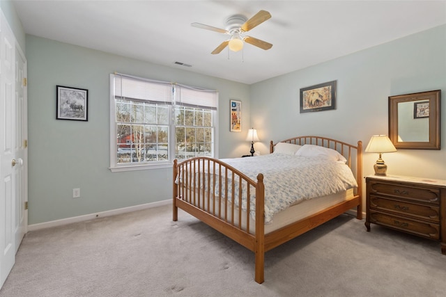 bedroom featuring light carpet, baseboards, visible vents, and a ceiling fan