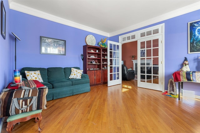 living area with french doors, wood finished floors, and crown molding