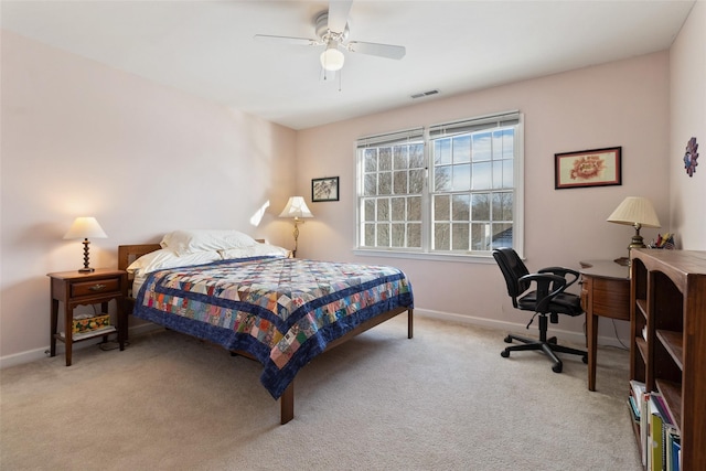 carpeted bedroom with baseboards, a ceiling fan, and an office area