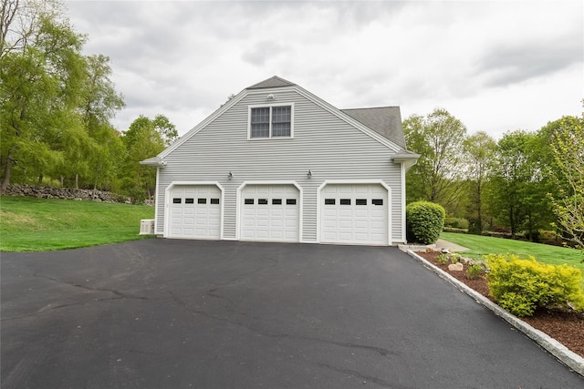 garage with asphalt driveway