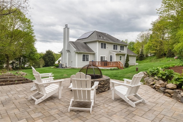 view of patio featuring a fire pit, a deck, and cooling unit