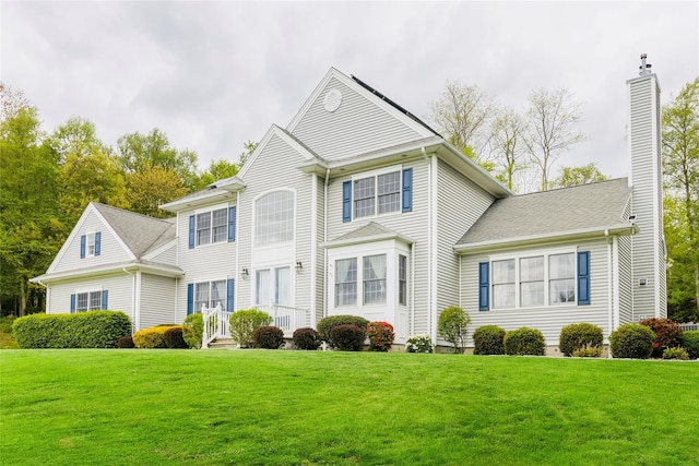 28 Teal Ln, Brewster, NY 10509 - colonial-style house with a front yard and a chimney