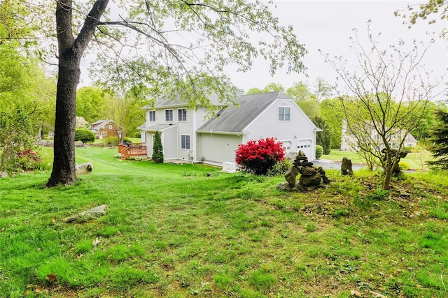 28 Teal Ln, Brewster, NY 10509 - back of property with a garage, a lawn, and a deck