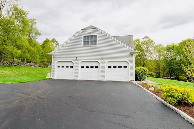 28 Teal Ln, Brewster, NY 10509 - view of side of home with a lawn, asphalt driveway, a garage, and view of scattered trees