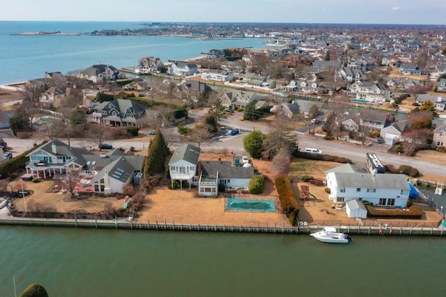 birds eye view of property with a water view and a residential view