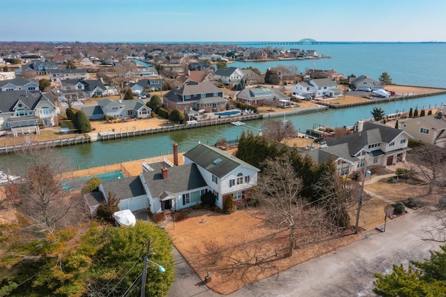 birds eye view of property with a water view and a residential view