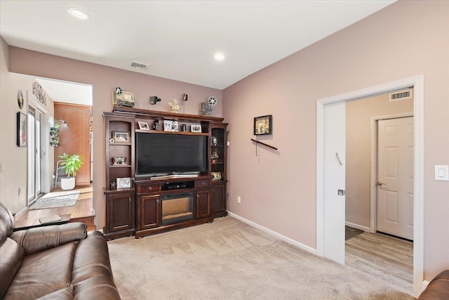 living room with recessed lighting, baseboards, visible vents, and light colored carpet