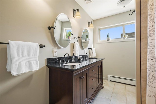 bathroom with double vanity, visible vents, a baseboard radiator, tile patterned floors, and a sink