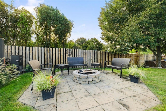 view of patio / terrace with an outdoor fire pit and fence