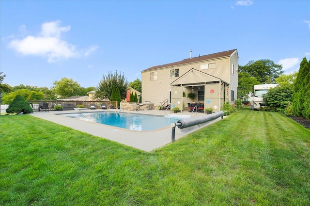 view of pool featuring a patio, a lawn, fence, and a fenced in pool