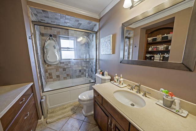 bathroom featuring vanity, ornamental molding, combined bath / shower with glass door, toilet, and tile patterned flooring