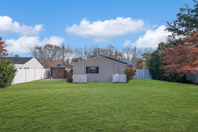 exterior space with a fenced backyard and an outbuilding