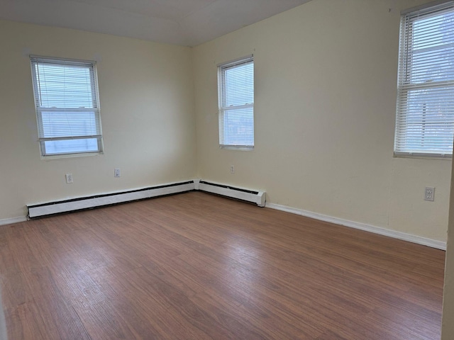 unfurnished room featuring baseboards and wood finished floors