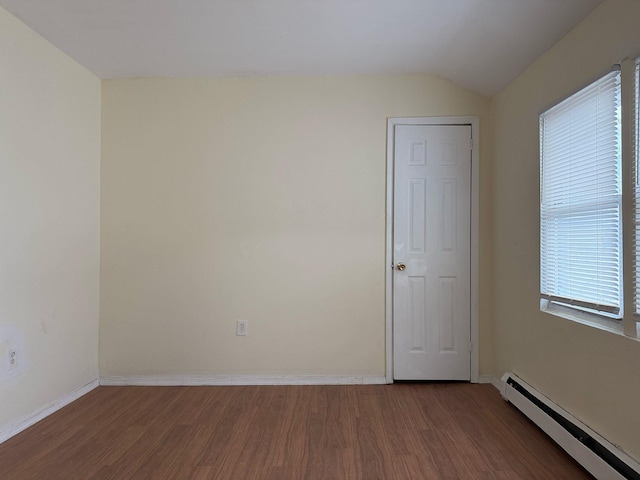 unfurnished room with dark wood-style floors, lofted ceiling, baseboards, and baseboard heating