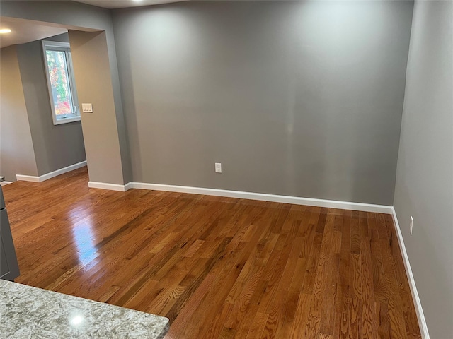 empty room with hardwood / wood-style floors