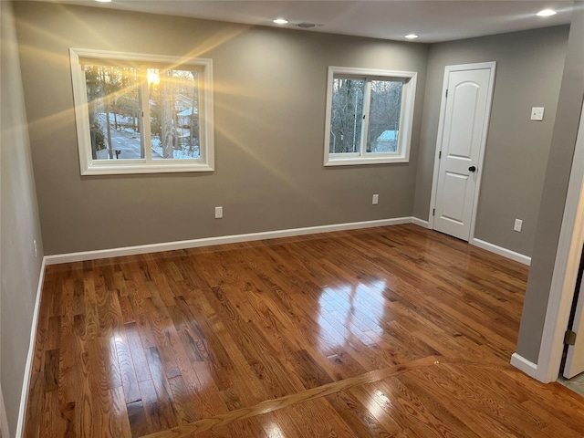 spare room with wood-type flooring