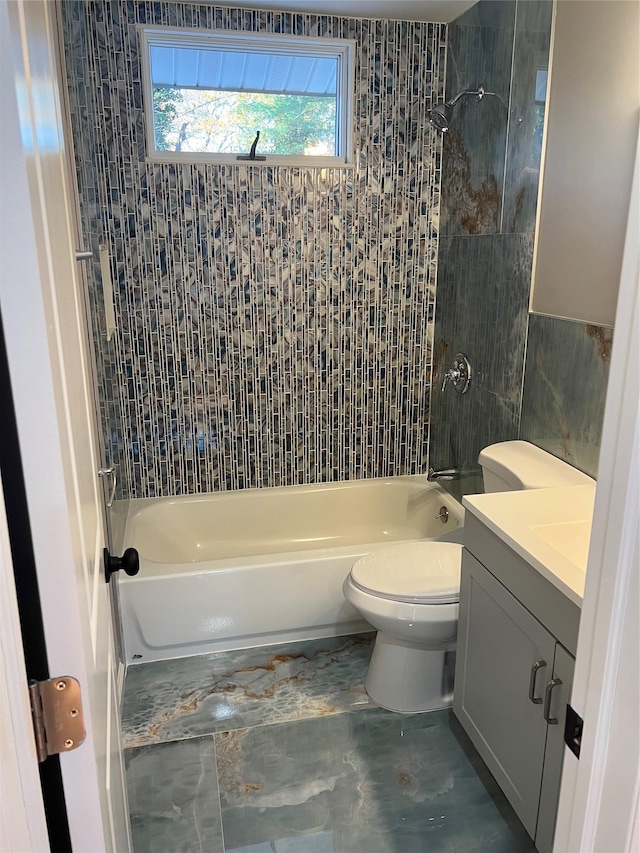 full bathroom with vanity, tiled shower / bath, and toilet