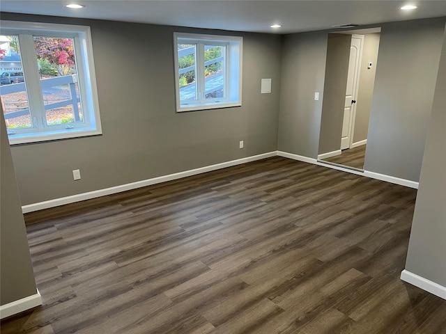 empty room with dark wood-type flooring