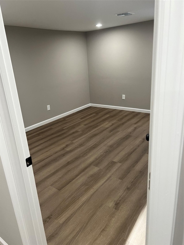 unfurnished room featuring dark hardwood / wood-style floors