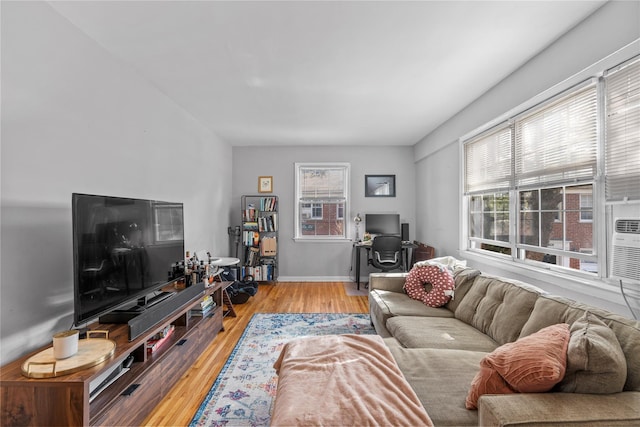 living area with light wood-style floors and baseboards