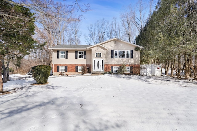 raised ranch featuring brick siding