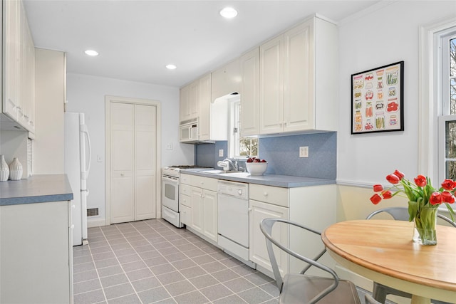 kitchen featuring white appliances, light tile patterned flooring, a sink, and recessed lighting