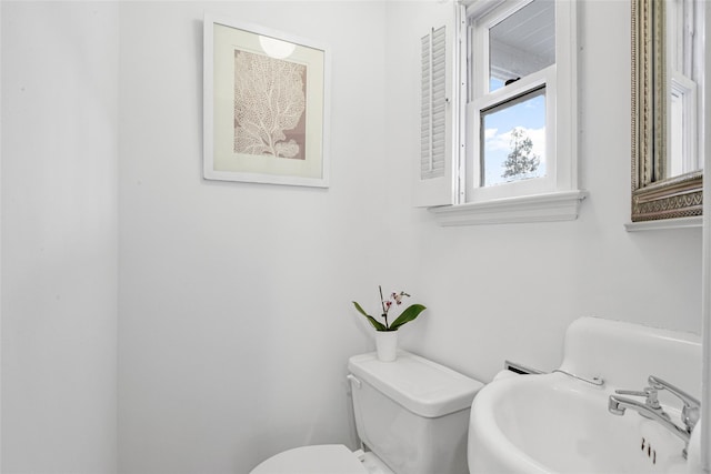 half bath featuring a sink and toilet