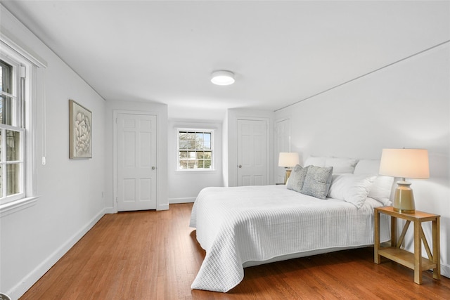 bedroom featuring baseboards and wood finished floors