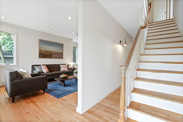 stairway with wood finished floors, recessed lighting, and baseboards