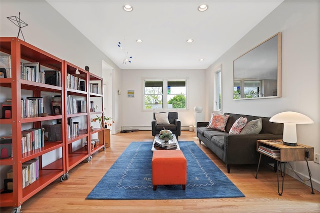 living room featuring wood finished floors, a baseboard heating unit, recessed lighting, and baseboards