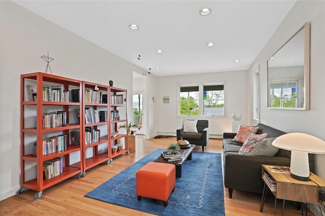 sitting room featuring wood finished floors, recessed lighting, a baseboard radiator, and baseboards