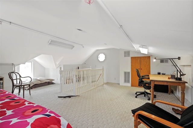 carpeted bedroom featuring lofted ceiling and an office area