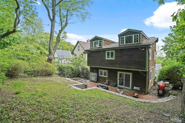 rear view of property featuring a patio area and a lawn