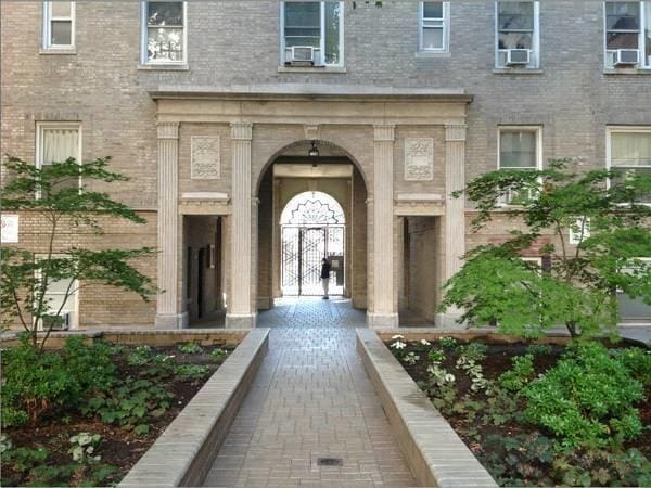 view of exterior entry featuring brick siding